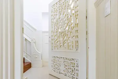 a hallway with a door with a patterned wall at Porto Riverville Apartments in Porto