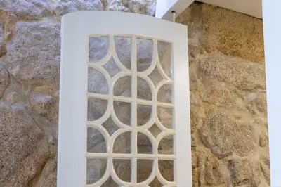a window in a stone wall with a white frame at Porto Riverville Apartments in Porto