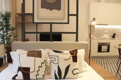 a bedroom with a bed with pillows on it at Modern Flat Near Trindade by LovelyStay in Porto