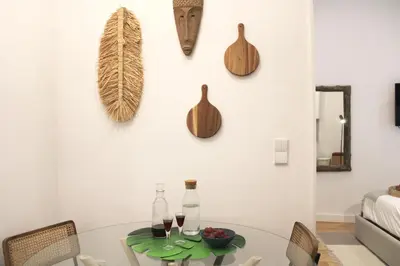 a dining room with a table and some bottles on the wall at Modern Flat Near Trindade by LovelyStay in Porto