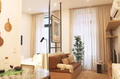 a living room with a couch and a bed at Modern Flat Near Trindade by LovelyStay in Porto