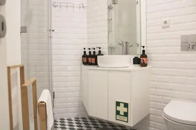 a white bathroom with a sink and a toilet at Modern Flat Near Trindade by LovelyStay in Porto
