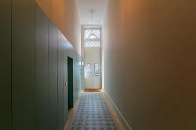 a hallway with a door and a tile floor at Luxurious Flat in City Center by LovelyStay in Porto