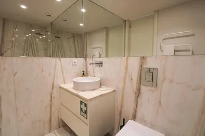 a bathroom with a sink and a mirror at Luxurious Flat in City Center by LovelyStay in Porto