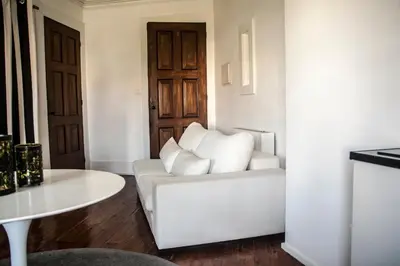 a living room with a white couch and a table at Oporto Loft in Porto