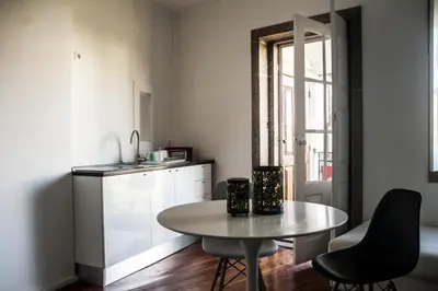 a small kitchen with a table and chairs in a room at Oporto Loft in Porto
