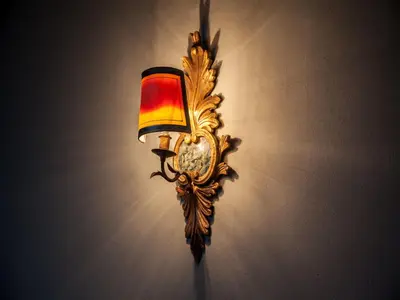 a light on a wall with a clock on it at Oporto Loft in Porto