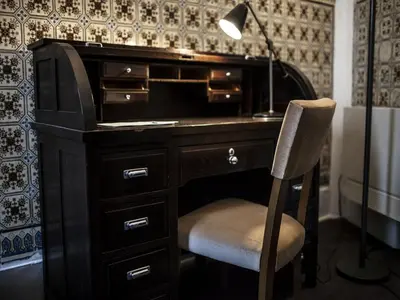 a desk with a lamp and a chair in a room at Oporto Loft in Porto