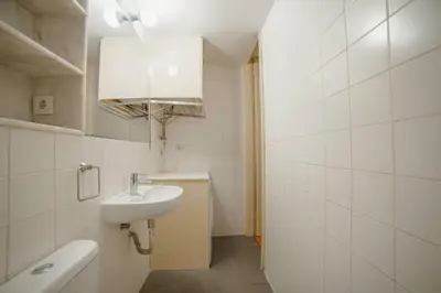 a white bathroom with a sink and a mirror at Vintage Flat by Hosty in Porto