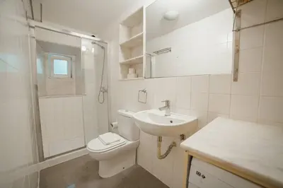 a white bathroom with a toilet and a sink at Vintage Flat by Hosty in Porto
