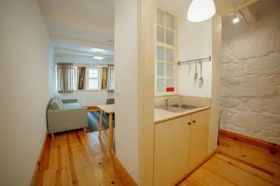 a kitchen with a sink and a table in a room at Vintage Flat by Hosty in Porto