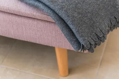 a close up of a purple couch with a blanket at GuestReady - Sunny terrace in downtown Porto in Porto
