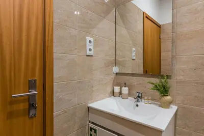 a bathroom with a sink and a mirror at GuestReady - Sunny terrace in downtown Porto in Porto