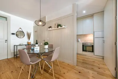 a kitchen and dining room with a glass table and chairs at GuestReady - Oporto Temptation Apartment in Porto