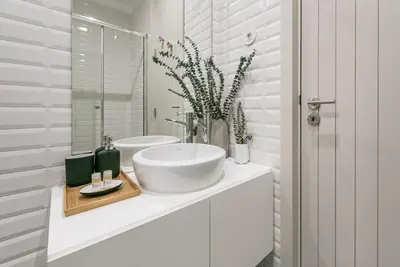 a white bathroom with a sink and a mirror at GuestReady - Oporto Temptation Apartment in Porto
