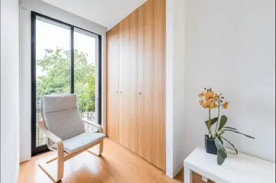 a room with a chair and a desk and a window at ApartmentsPorto - Leisure Fun Apartment in Porto
