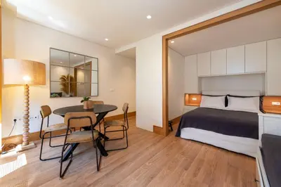 a bedroom with a bed and a table and chairs at PortoPoint in Porto
