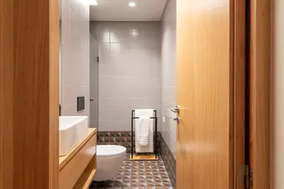 a bathroom with a toilet and a tub and a sink at PortoPoint in Porto