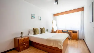 a bedroom with a bed and a window at Cedofeita Vintage w Free Parking by LovelyStay in Porto