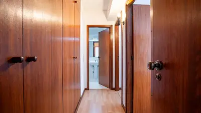 a hallway with wooden doors and a hallway with at Cedofeita Vintage w Free Parking by LovelyStay in Porto