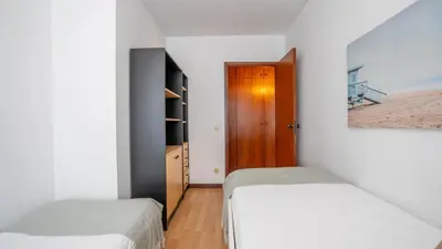 a small bedroom with two beds and a wooden door at Cedofeita Vintage w Free Parking by LovelyStay in Porto