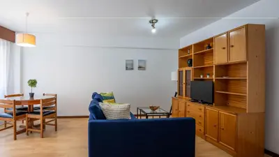a living room with a blue couch and a table at Cedofeita Vintage w Free Parking by LovelyStay in Porto