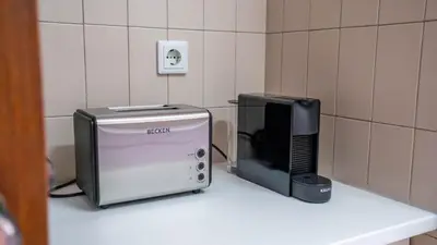 a microwave and a television sitting on a counter at Cedofeita Vintage w Free Parking by LovelyStay in Porto