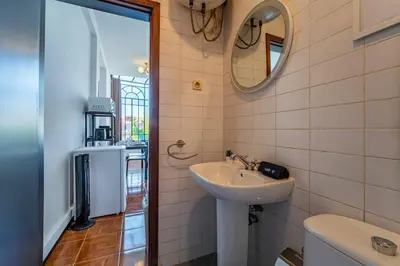 a bathroom with a sink and a mirror at Heritage Oporto Downtown in Porto