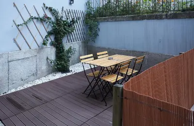 a wooden table and chairs sitting on a patio at ChillHouse_Porto in Porto
