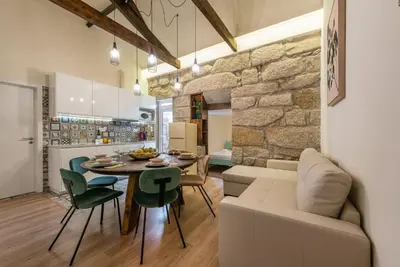 a living room and kitchen with a table and a couch at GuestReady - Cosy getaway in Porto in Vila Nova de Gaia