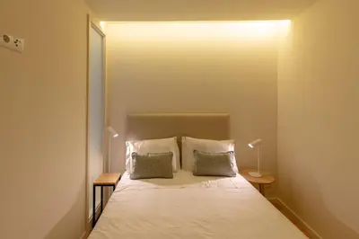 a bedroom with a bed with two pillows at GuestReady - Catorze de Outubro Houses 427 in Vila Nova de Gaia