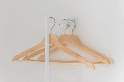 a group of wooden hangers hanging on a wall at GuestReady - Port Studio 1 in Vila Nova de Gaia
