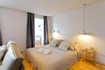 a bedroom with a bed with two towels on it at GuestReady - Climbing Loft in Porto
