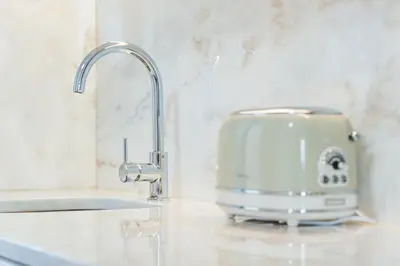 a toaster sitting on a kitchen counter next to a sink at HiddenGem - Cotton Strings in Porto