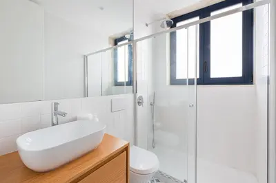 a white bathroom with a sink and a shower at HiddenGem - Cotton Strings in Porto
