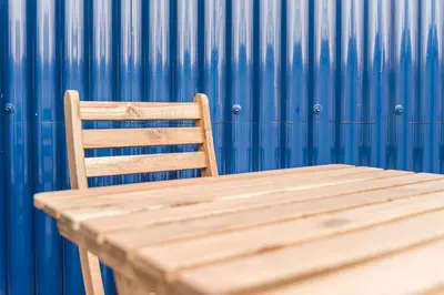 a wooden bench sitting in front of a blue wall at HiddenGem - Cotton Strings in Porto