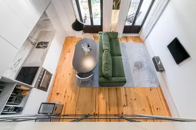 a living room with a green couch and a table at GuestReady - Loft 515 in Porto
