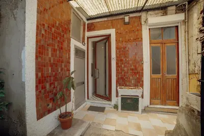 a brick building with a door and a potted plant at Douro Panoramic Views by Vacationy in Porto