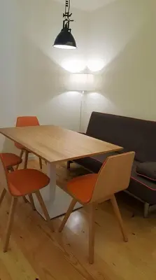 a wooden table with two chairs and a lamp at GuestReady - Catorze de Outubro Houses - 387 in Vila Nova de Gaia