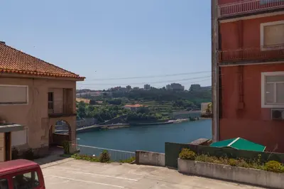 a view of a river between two buildings at dvnest - Premium 1BR Apartment with River View! in Porto