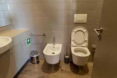a bathroom with a toilet and a sink at dvnest - Premium 1BR Apartment with River View! in Porto