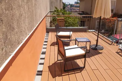 three chairs and a table on a balcony at dvnest - Premium 1BR Apartment with River View! in Porto