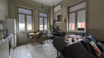a living room with a couch and a table at dvnest - Premium 1BR Apartment with River View! in Porto