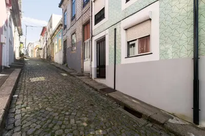 an empty street in an alley with buildings at Lady Lapa by Lady Collection in Porto
