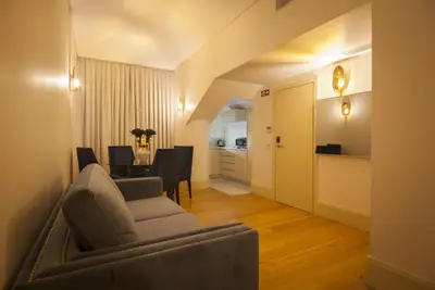 a living room with a couch and a dining room at Oca Flores Hotel Boutique in Porto