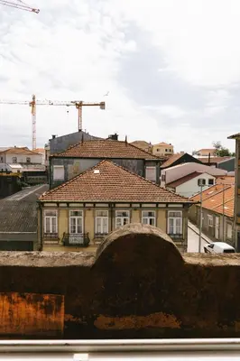 a house with a tile roof in a city at Studio Faria Guimarães in Porto