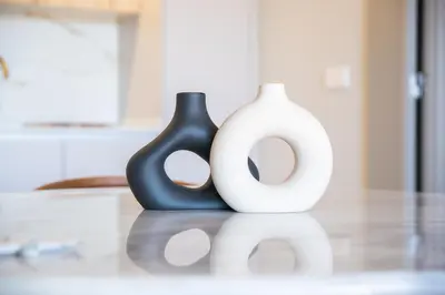 two black and white vases sitting on a table at Brand New Luxurious Ap T2 - Amazing View- with garage in Vila Nova de Gaia