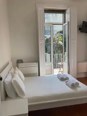 a building with a white door and a balcony at Pombeiro Apartments in Porto