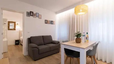 a living room with a couch and a table and a chair at Stop & Relax - Parking in Porto
