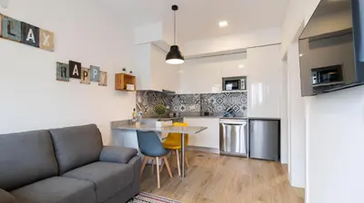 a living room with a couch and a table at Stop & Relax - Parking in Porto